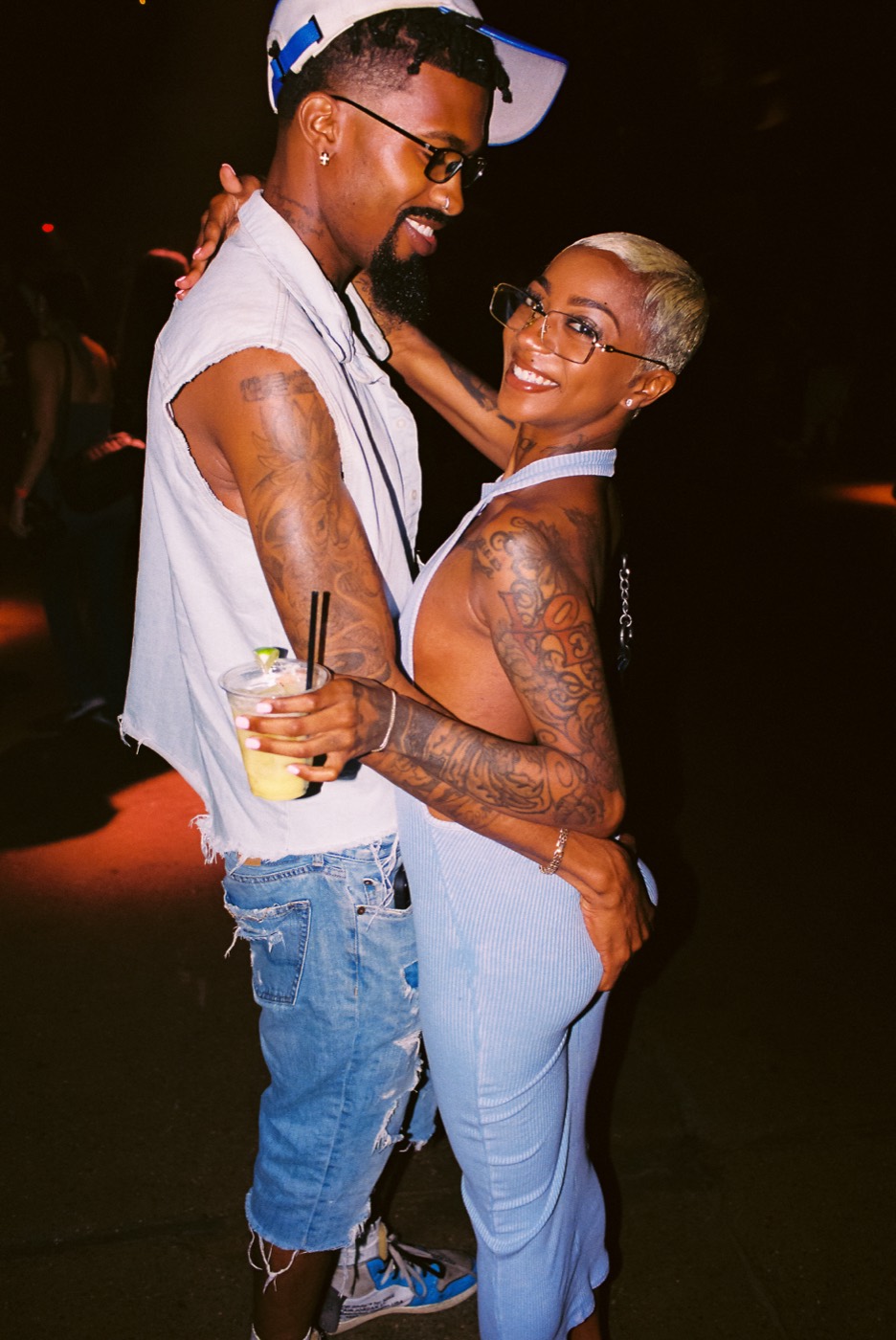 A couple dancing close together in warm light